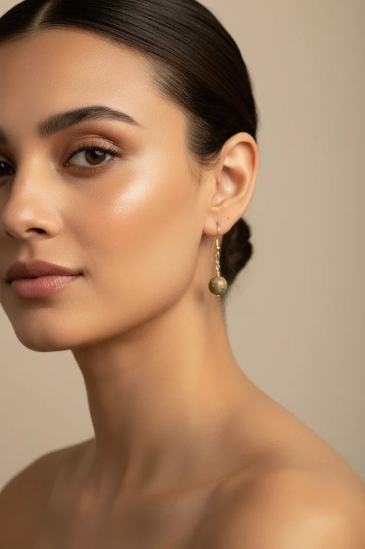 Mulher usando brincos de unakita